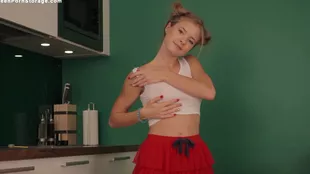 A young woman showcases her skills in the kitchen while wearing a skirt