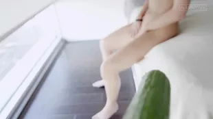 Lena N enjoys a refreshing solo bath with a cucumber